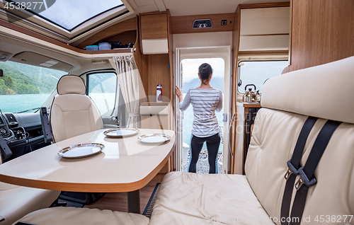 Image of Woman in the interior of a camper RV motorhome with a cup of cof