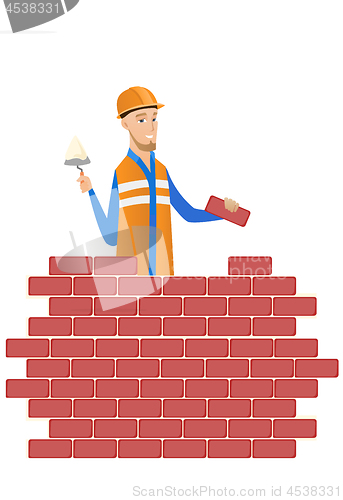 Image of Young bricklayer working with spatula and brick.