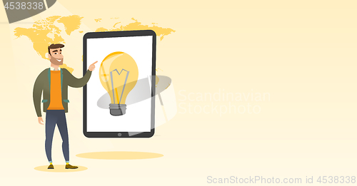 Image of Caucasian man pointing at a big tablet computer.