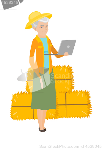 Image of Senior caucasian farmer using a laptop.