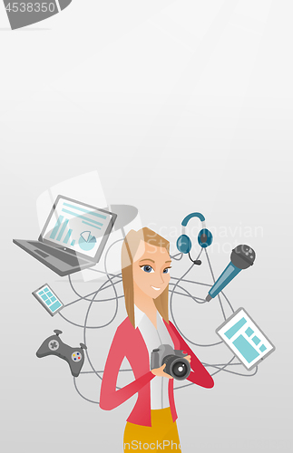 Image of Young caucasian woman surrounded by her gadgets.