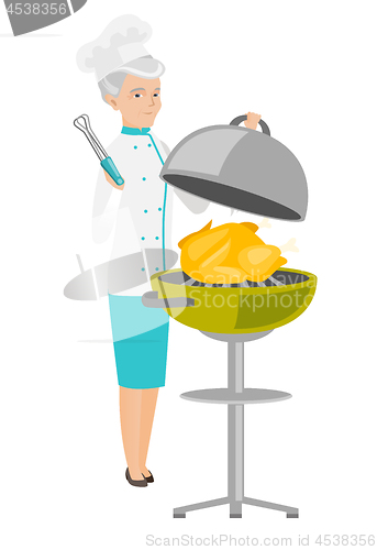 Image of Caucasian chef cooking chicken on barbecue grill.