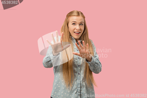 Image of Portrait of the scared woman on pink