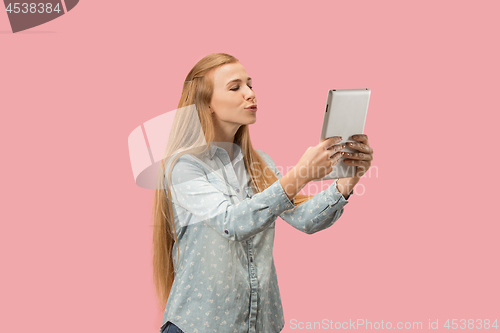 Image of The happy businesswoman with red laptop on pink