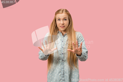 Image of Portrait of the scared woman on pink