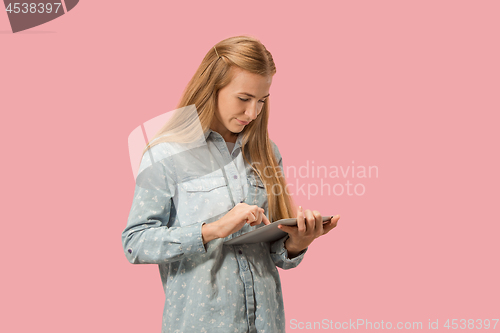Image of The happy businesswoman with red laptop on pink