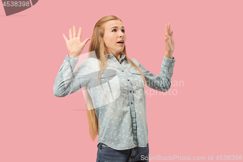 Image of Portrait of the scared woman on pink