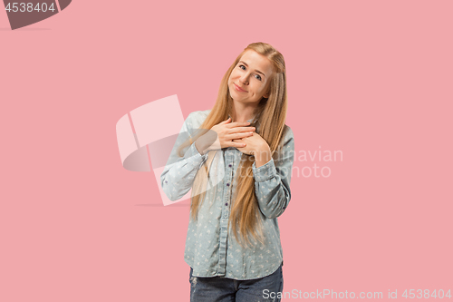 Image of The happy business woman standing and smiling against pink background.