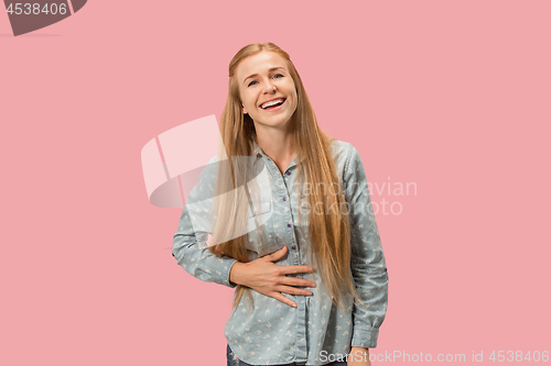 Image of The happy business woman standing and smiling against pink background.