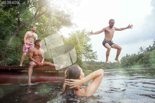 Image of Enjoying river party with friends. Group of beautiful happy young people at the river together