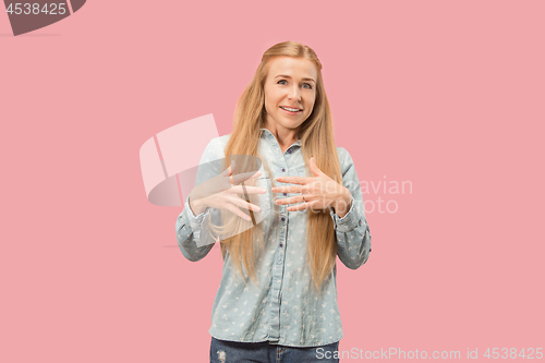 Image of The happy business woman standing and smiling against pink background.