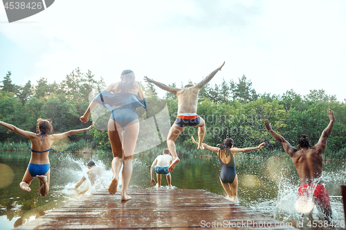 Image of Enjoying river party with friends. Group of beautiful happy young people at the river together