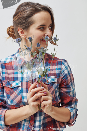 Image of Young girl with flowers eryngium