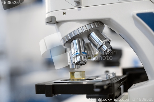 Image of White microscope close-up photo inside laboratory