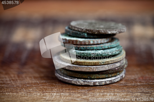 Image of Stack of different ancient copper coins with patina.