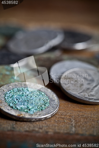 Image of Pile of different ancient copper coins ccloseup on rustic wooden