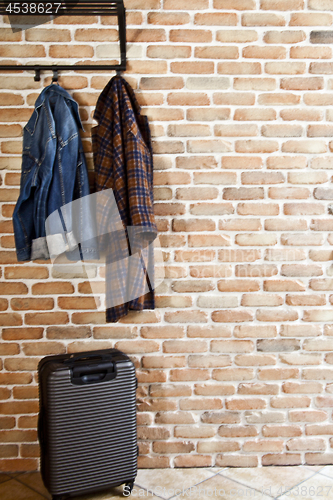 Image of Modern hallway loft interior with denim coat and jacket on hange