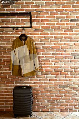 Image of Modern hallway loft interior with mustard yellow jacket on hange