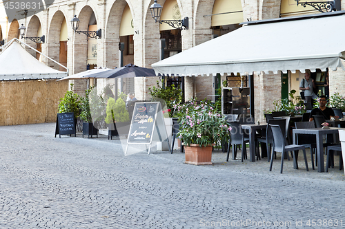 Image of Fermo, Italy - June 23, 2019: Summer day and utdoor restaurant