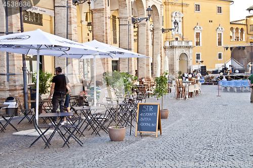 Image of Fermo, Italy - June 23, 2019: People enjoying summer day and foo