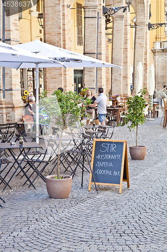 Image of Fermo, Italy - June 23, 2019: People enjoying summer day and foo