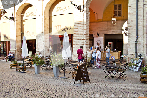 Image of Fermo, Italy - June 23, 2019: People enjoying summer day and foo