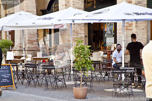 Image of Fermo, Italy - June 23, 2019: People enjoying summer day and foo