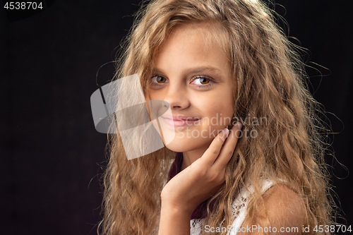 Image of Close-up portrait of teenage girl on black background