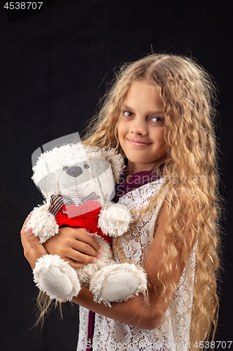 Image of Portrait of a teenage girl with an old toy bear