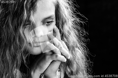 Image of Psychological black and white portrait of a girl on a black background