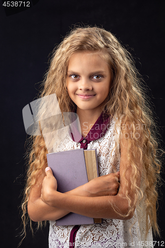 Image of Portrait of a teenage girl with an old book