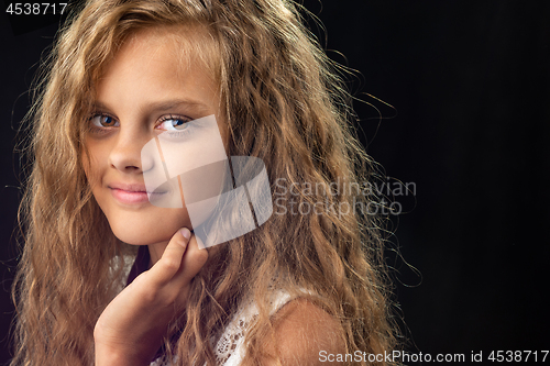 Image of Portrait of a teenage girl with long curly hair