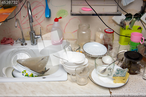 Image of Unwashed dishes on the table of the old kitchen