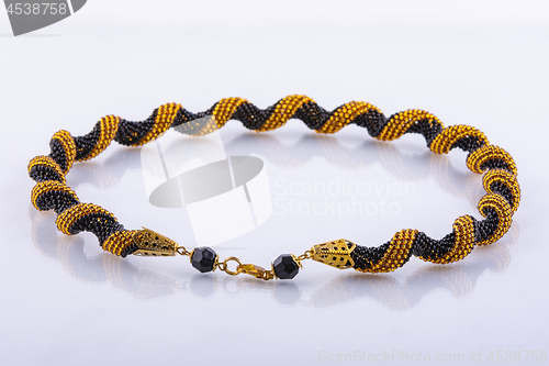 Image of Small handmade beaded bracelet made of black and gold beads
