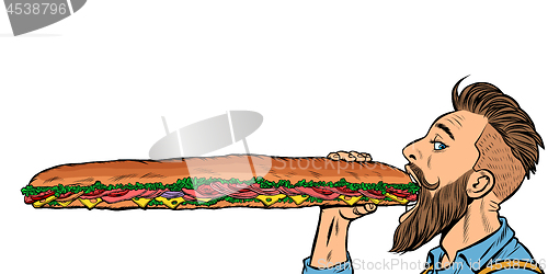 Image of man eats a long sandwich