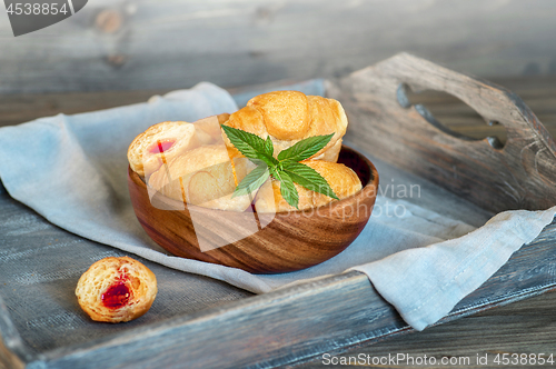 Image of Croissants on a wooden tray. The concept of a wholesome breakfast.