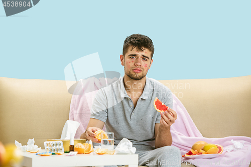 Image of Young man suffering from allergy to citrus fruits