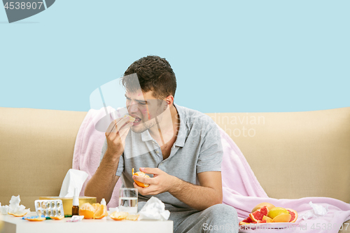 Image of Young man suffering from allergy to citrus fruits