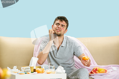 Image of Young man suffering from allergy to citrus fruits