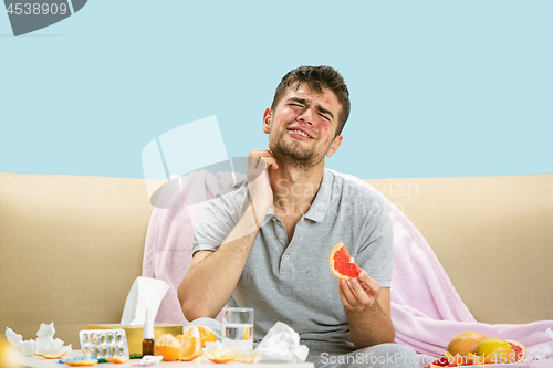 Image of Young man suffering from allergy to citrus fruits