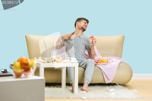 Image of Young man suffering from allergy to citrus fruits