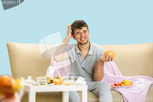 Image of Young man suffering from allergy to citrus fruits