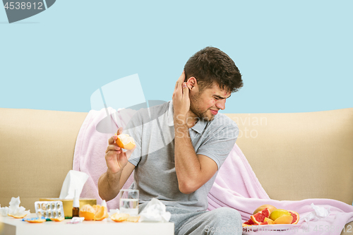 Image of Young man suffering from allergy to citrus fruits