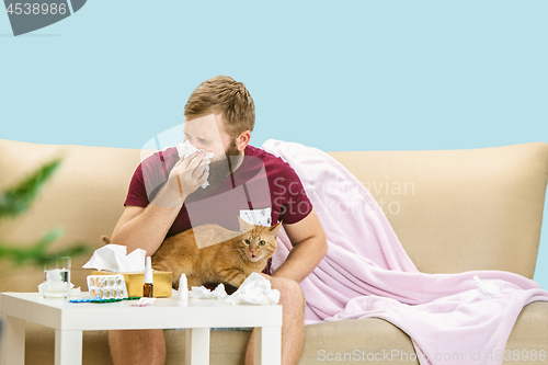 Image of Young man suffering from allergy to cat hair