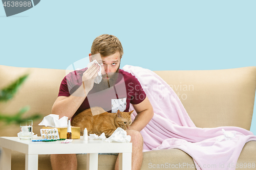 Image of Young man suffering from allergy to cat hair