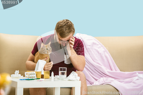 Image of Young man suffering from allergy to cat hair