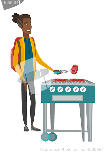 Image of Traveler man cooking steak on barbecue grill.