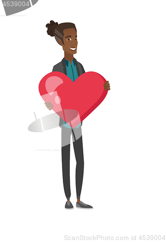 Image of Young african-american man holding a big heart.