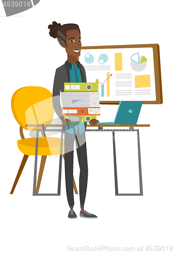 Image of Young african employee holding pile of folders.