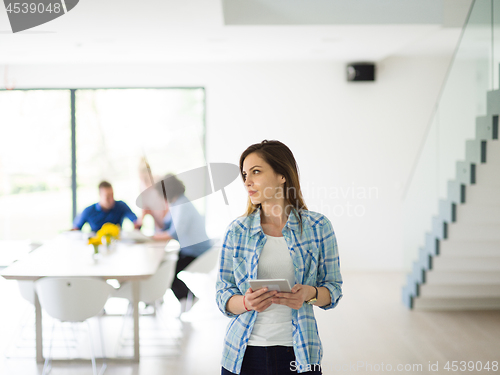 Image of Portrait of  smiling casual businesswoman using tablet  with cow